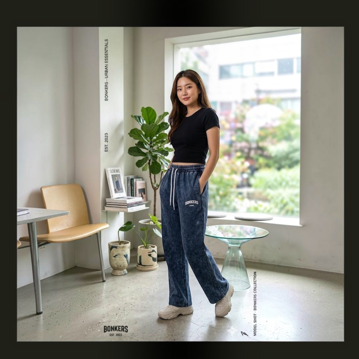 City Center premium Korean-style acid wash blue denim joggers worn by a woman with a black crop top in a bright room