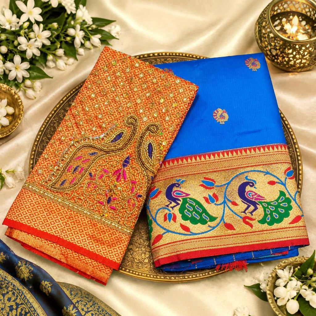 City Center designer saree featuring a blue fabric with peacock border and an orange blouse with intricate embroidery.