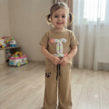 City Center Korian co-ord set featuring a beige ribbed t-shirt with floral detail and matching wide-leg trousers