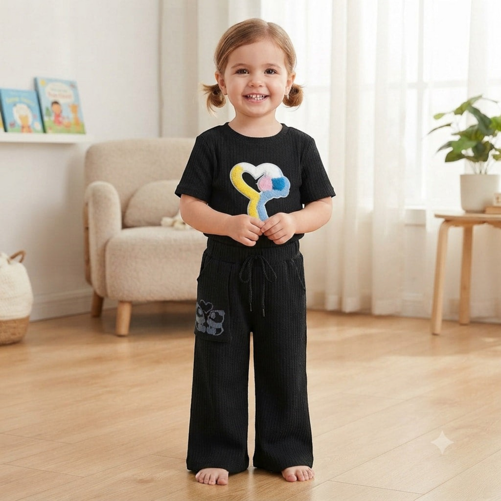 City Center black ribbed co-ord set featuring a heart graphic t-shirt and wide-leg trousers worn by a young girl