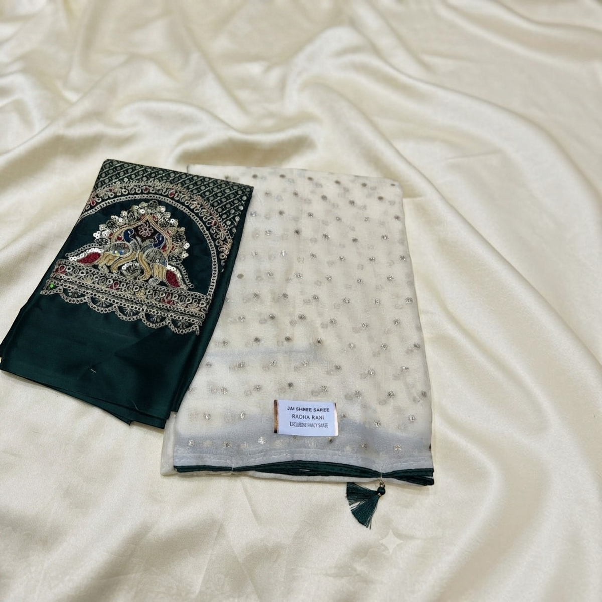 City Center Radha Rani saree featuring an off-white sheer fabric with silver sequins and a dark green embroidered pallu
