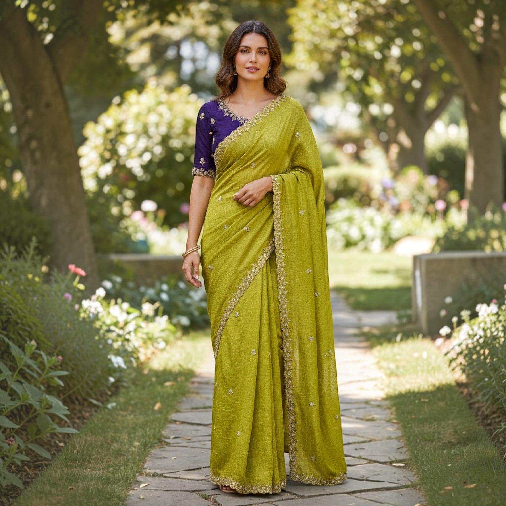 City Center olive green organza saree with intricate beadwork and a contrasting purple blouse worn in a garden.