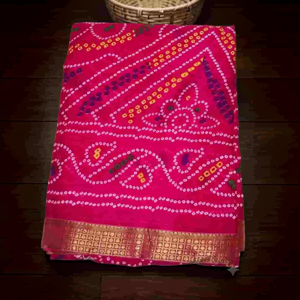 City Center Bandhan silk saree in vibrant pink with traditional bandhani tie-dye patterns and a gold woven border.