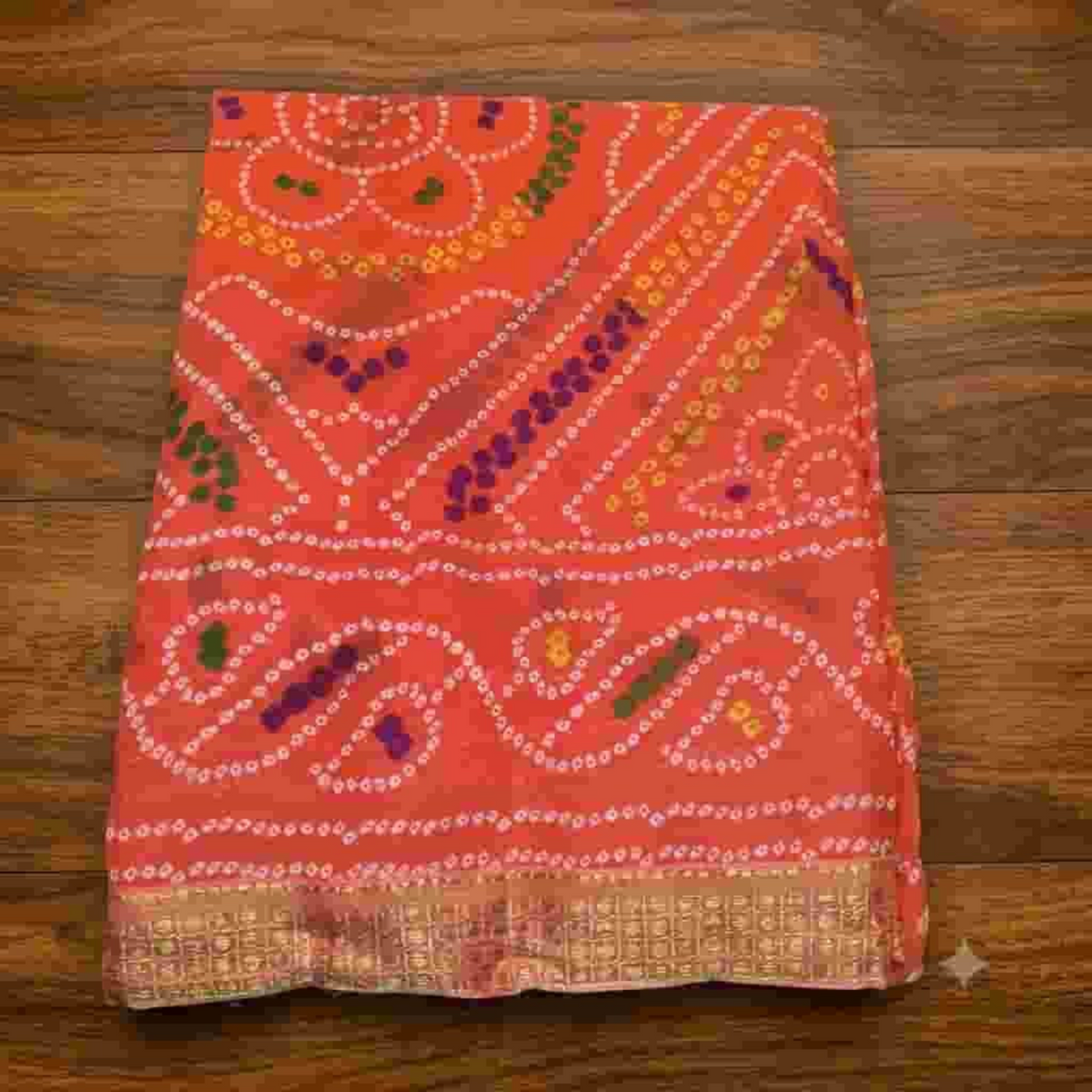 City Center Bandhan silk saree in vibrant orange with traditional bandhani tie-dye patterns and a gold woven border.