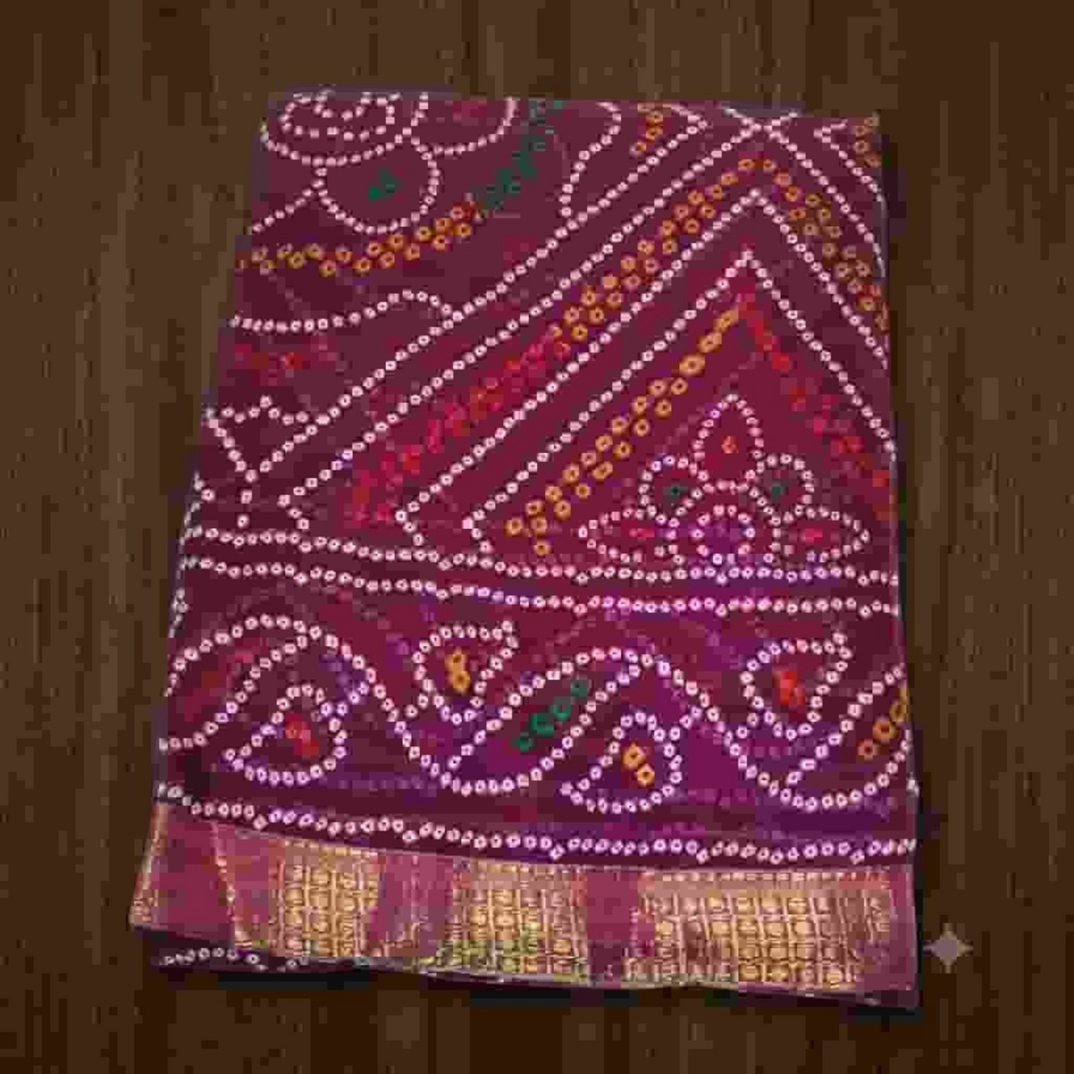 City Center Bandhan silk saree in deep maroon with traditional white bandhani tie-dye patterns and a gold zari border.