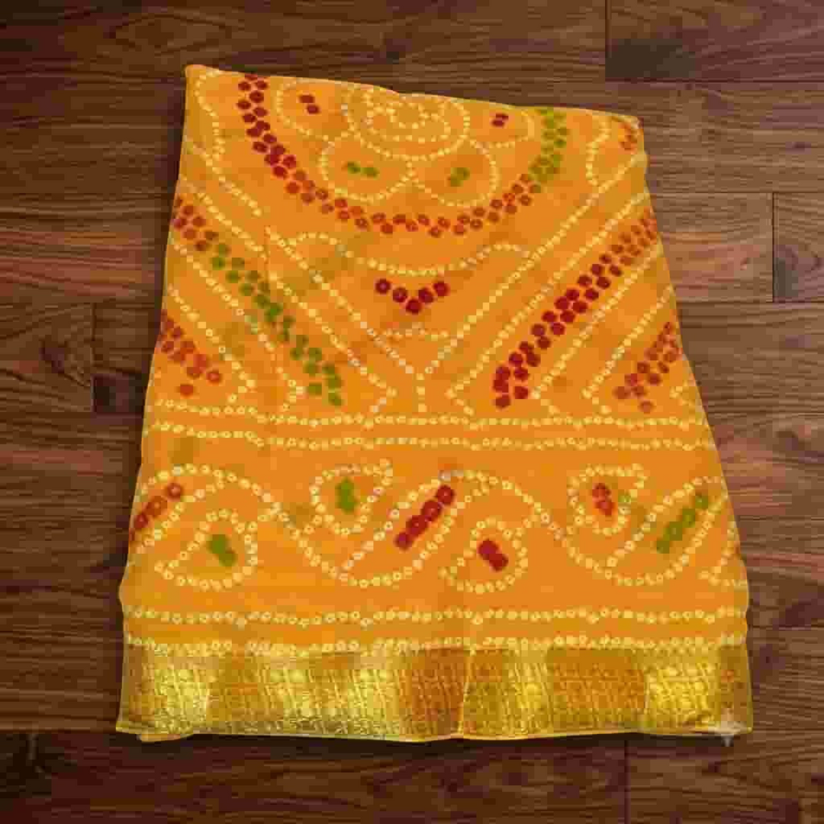 City Center Bandhan silk saree in vibrant yellow with traditional red and green bandhani tie-dye patterns and gold border