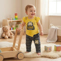 City Center baby girl yellow bunny graphic t-shirt and grey plaid pants set worn by a smiling toddler