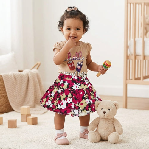 City Center baby girl outfit featuring a beige graphic t-shirt and a vibrant floral flared skirt with pink shoes