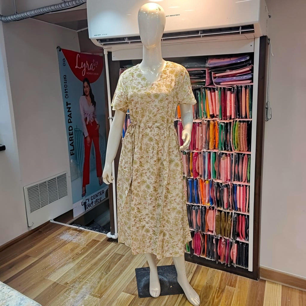 City Center beige floral print midi dress with v-neck and cinched waist on a mannequin in a retail store