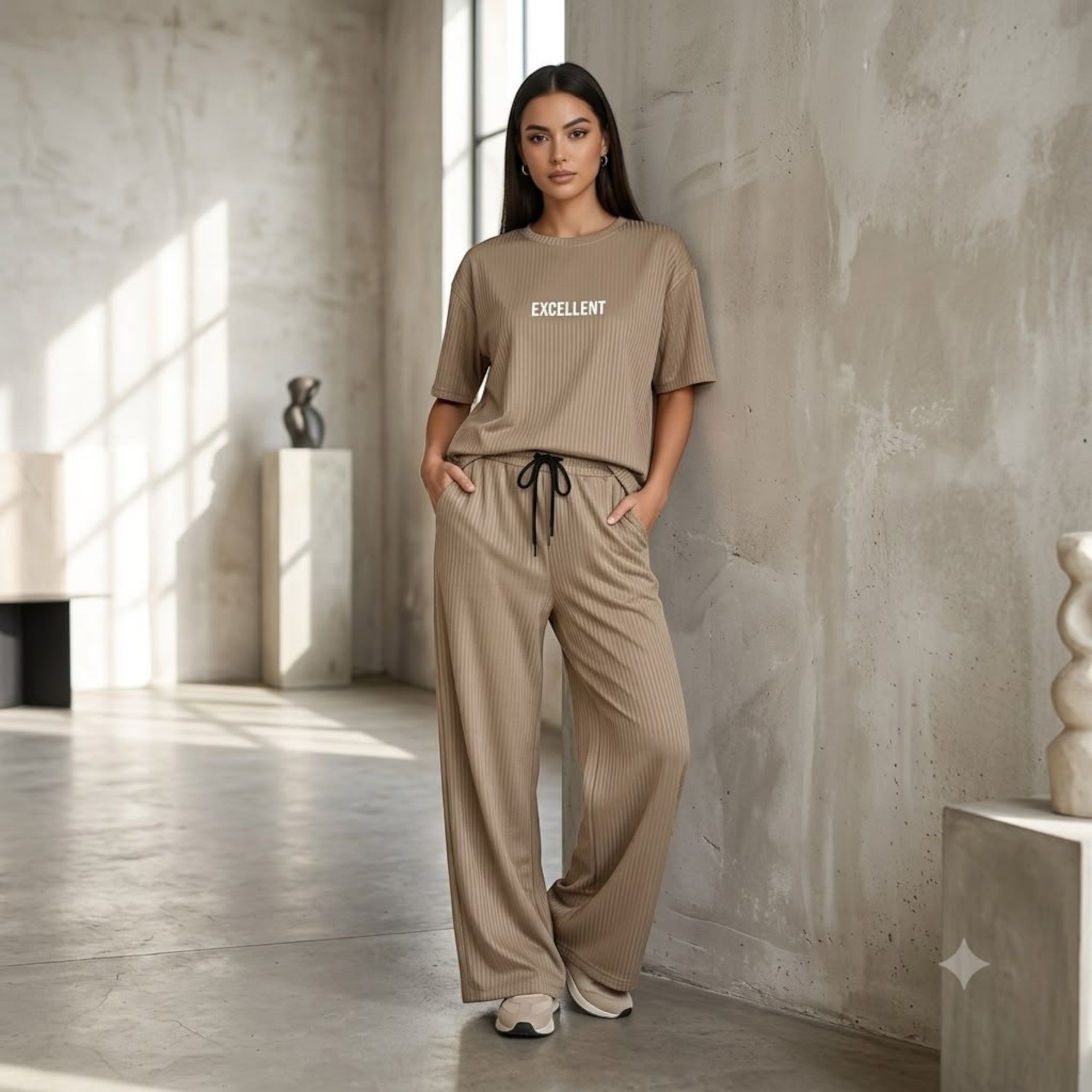 City Center beige ribbed cord set featuring an oversized t-shirt and wide-leg trousers worn by a model in a studio.