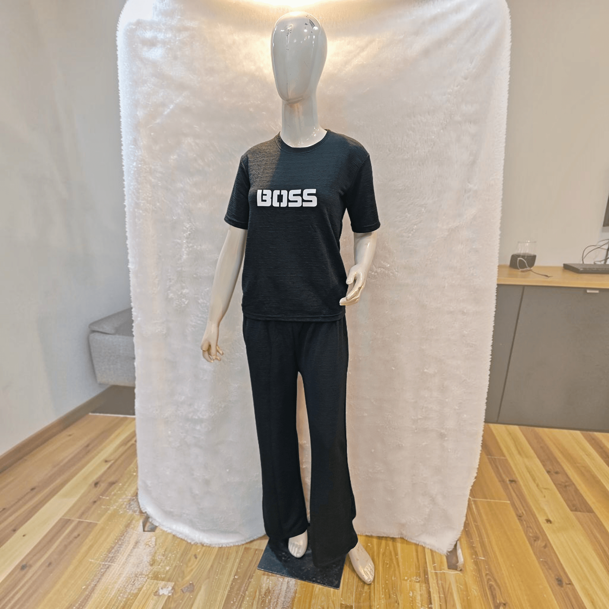 City Center black Korean airport cord set with BOSS graphic on a mannequin, featuring wrinkle-free soft-blend fabric.