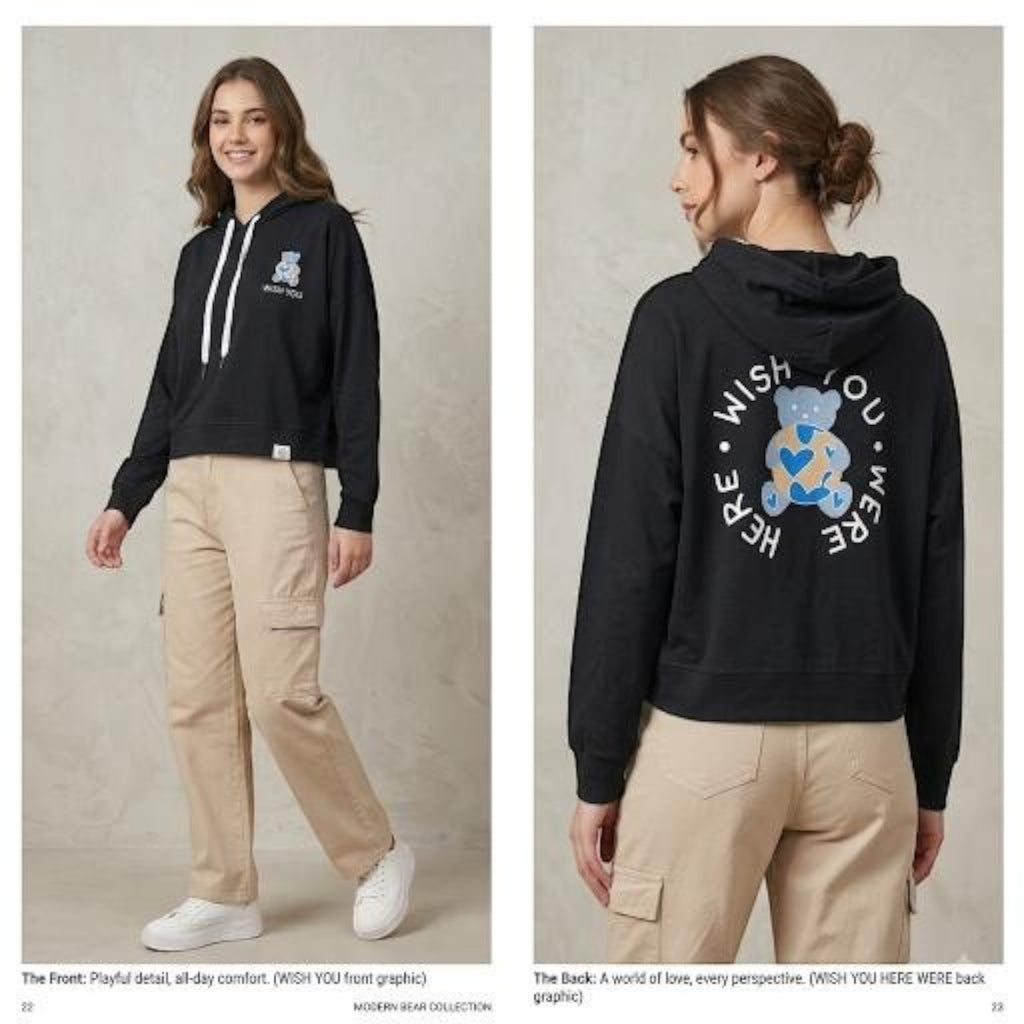 City Center black cropped hoodie with a bear graphic and Wish You Were Here text, worn with beige cargo pants.
