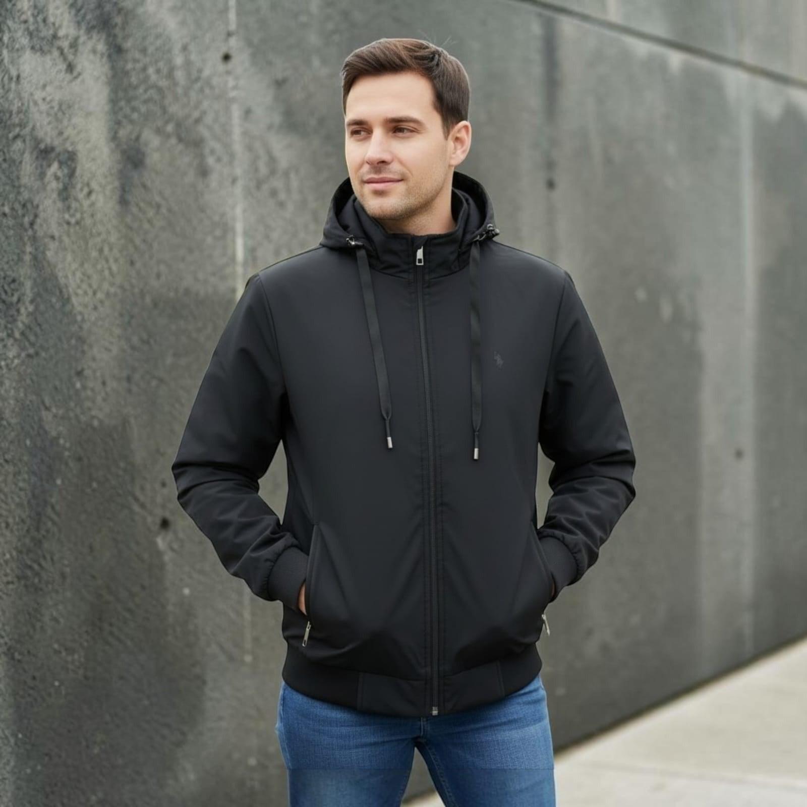 City Center light weight black hooded jacket with a zip-up front and ribbed cuffs worn by a man against a grey wall
