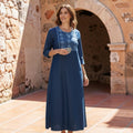 City Center blue cotton denim kurti with intricate embroidery on the yoke, worn by a woman in a stone courtyard.
