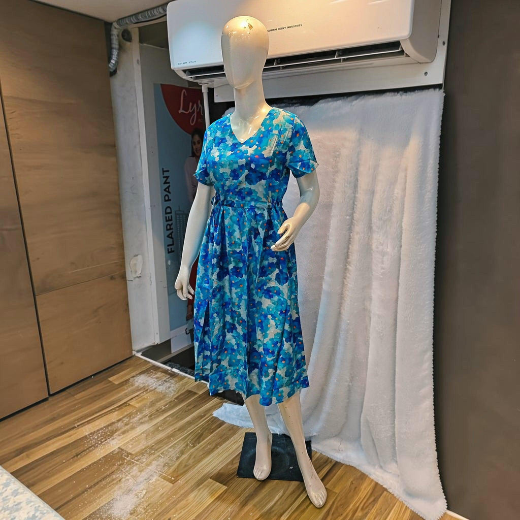 City Center blue floral print midi dress with a V-neck and cinched waist on a mannequin