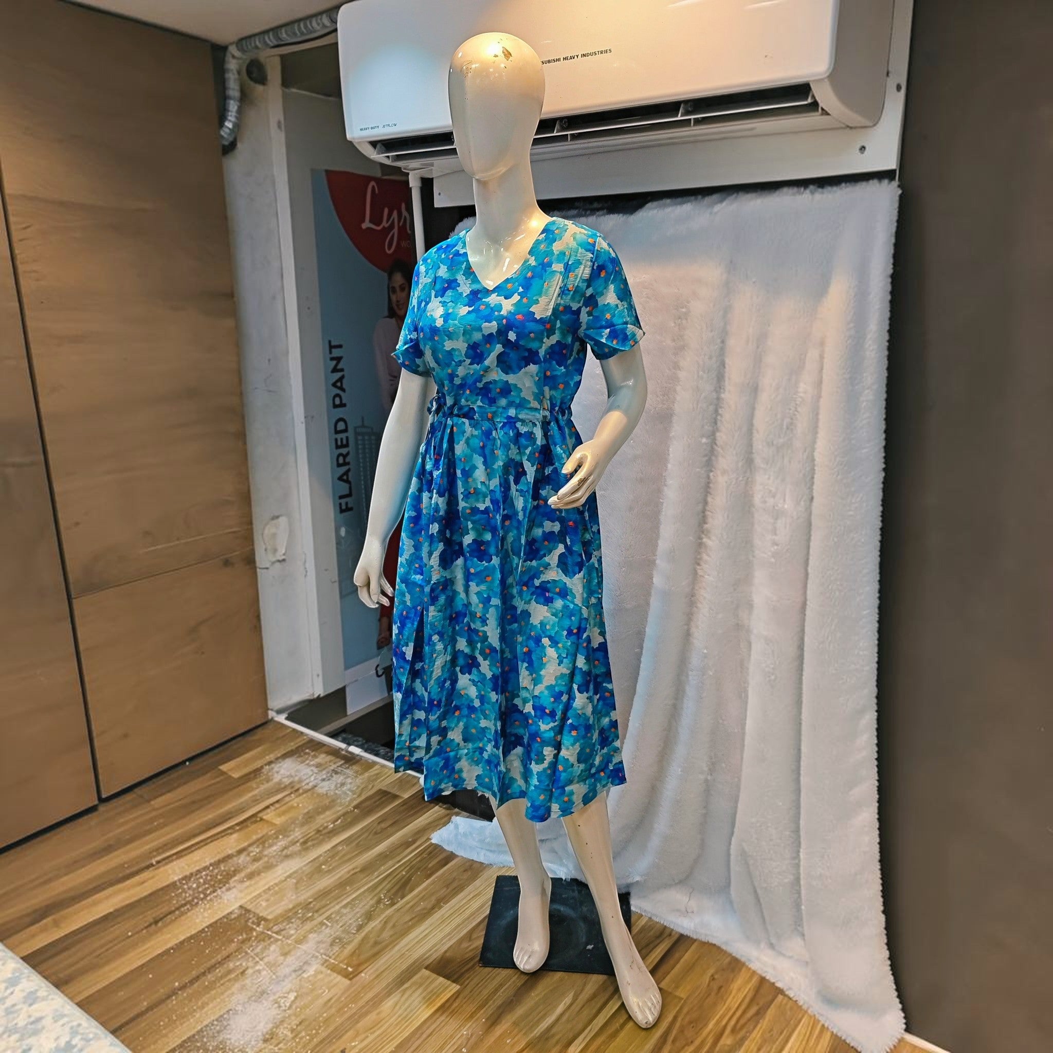 City Center blue floral print midi dress with a V-neck and cinched waist on a mannequin