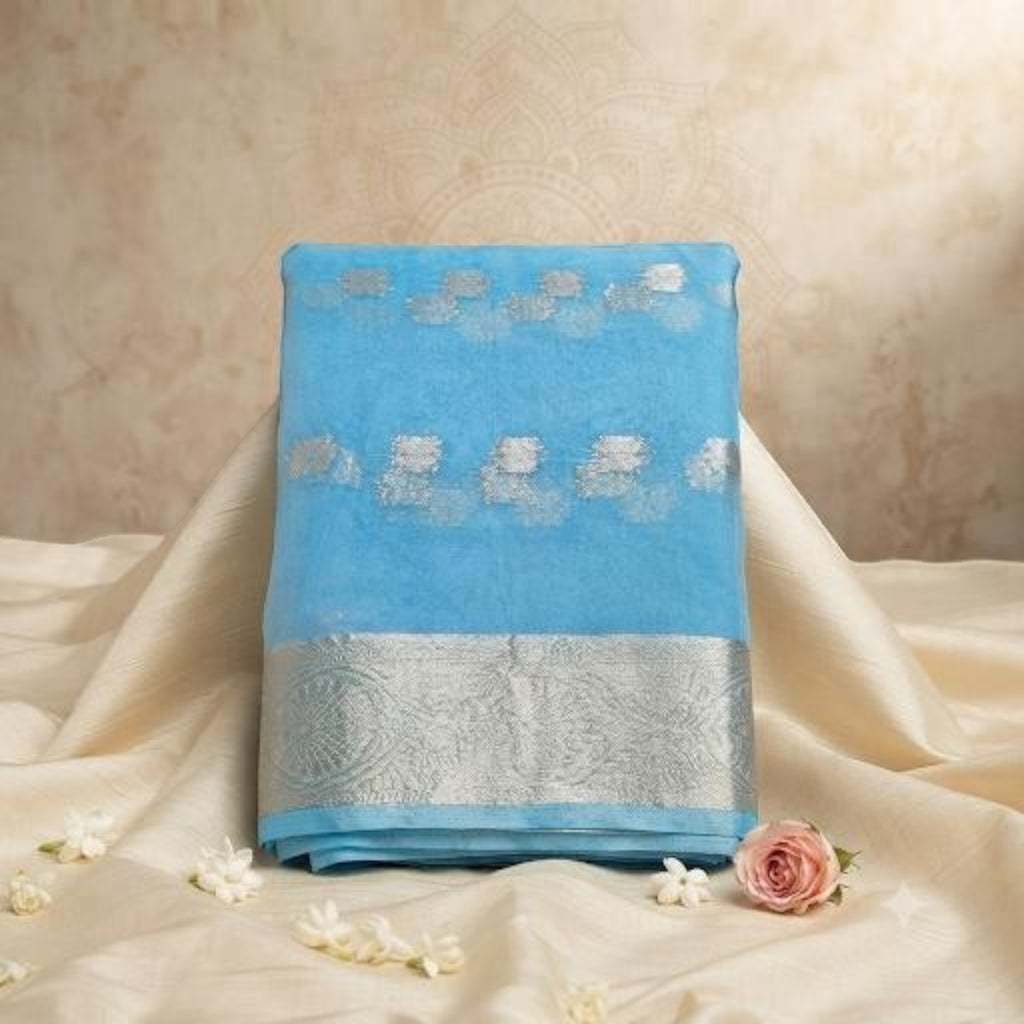 City Center light blue organza saree featuring intricate silver beet work embroidery and a wide metallic border.