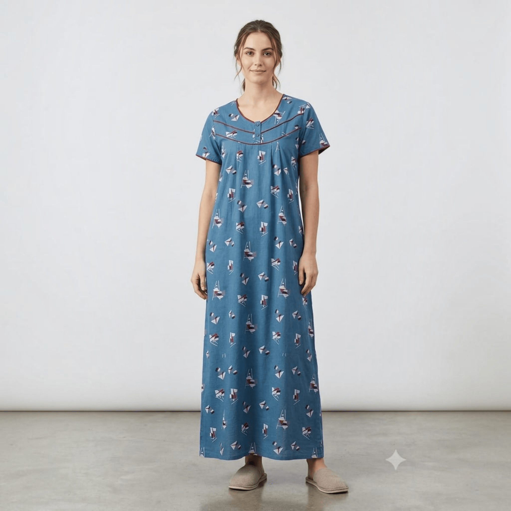 City Center blue alpine fabric feeding gown with sailboat print, neck embroidery, and relaxed A-line fit on a model.