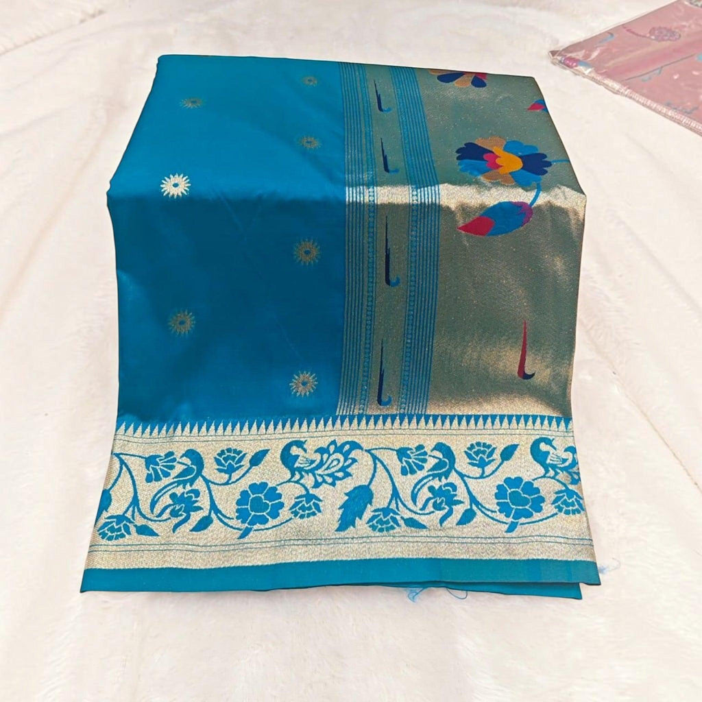 City Center traditional blue silk saree featuring a wide gold border with intricate floral and peacock motifs.