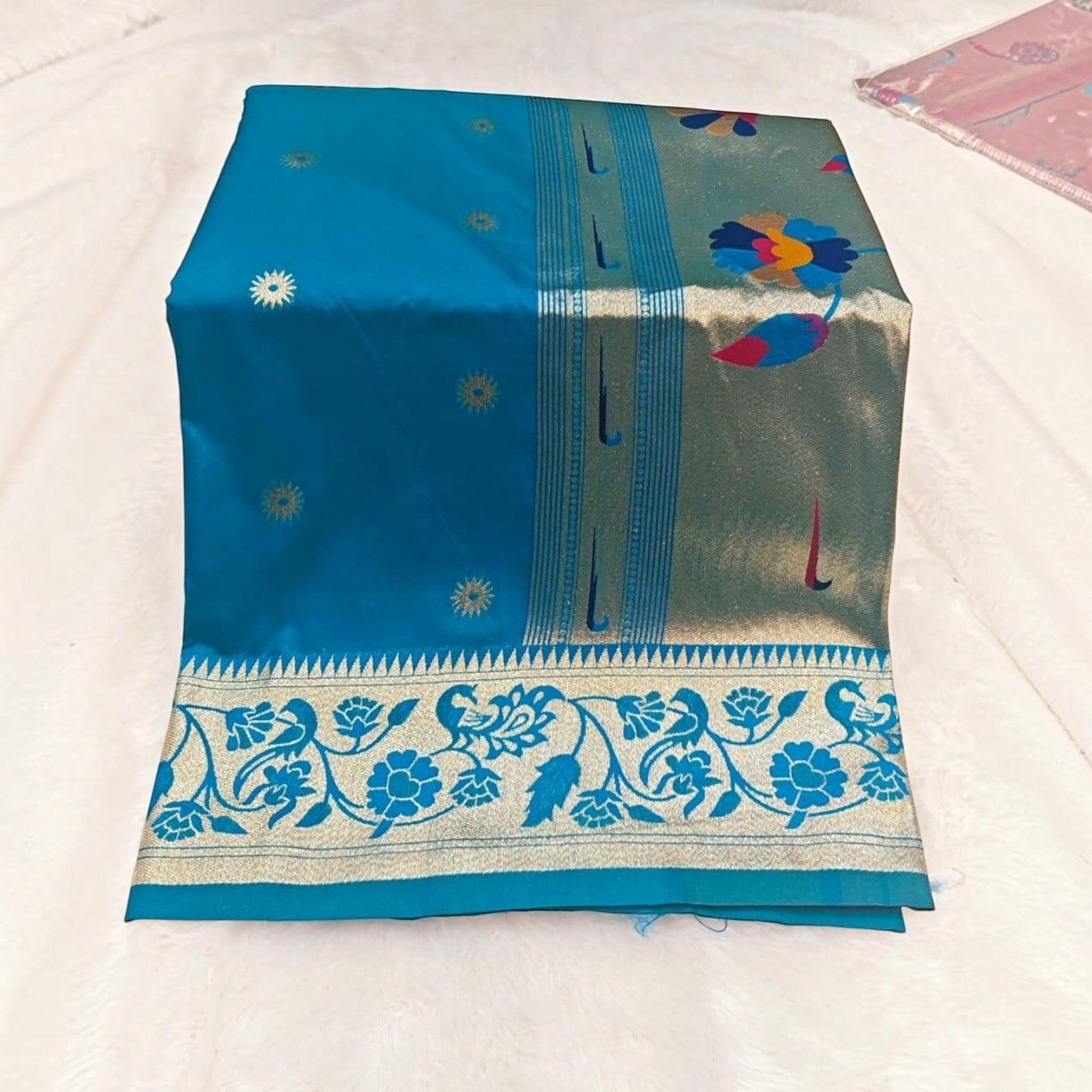 City Center traditional blue silk saree featuring a wide gold border with intricate floral and peacock motifs.