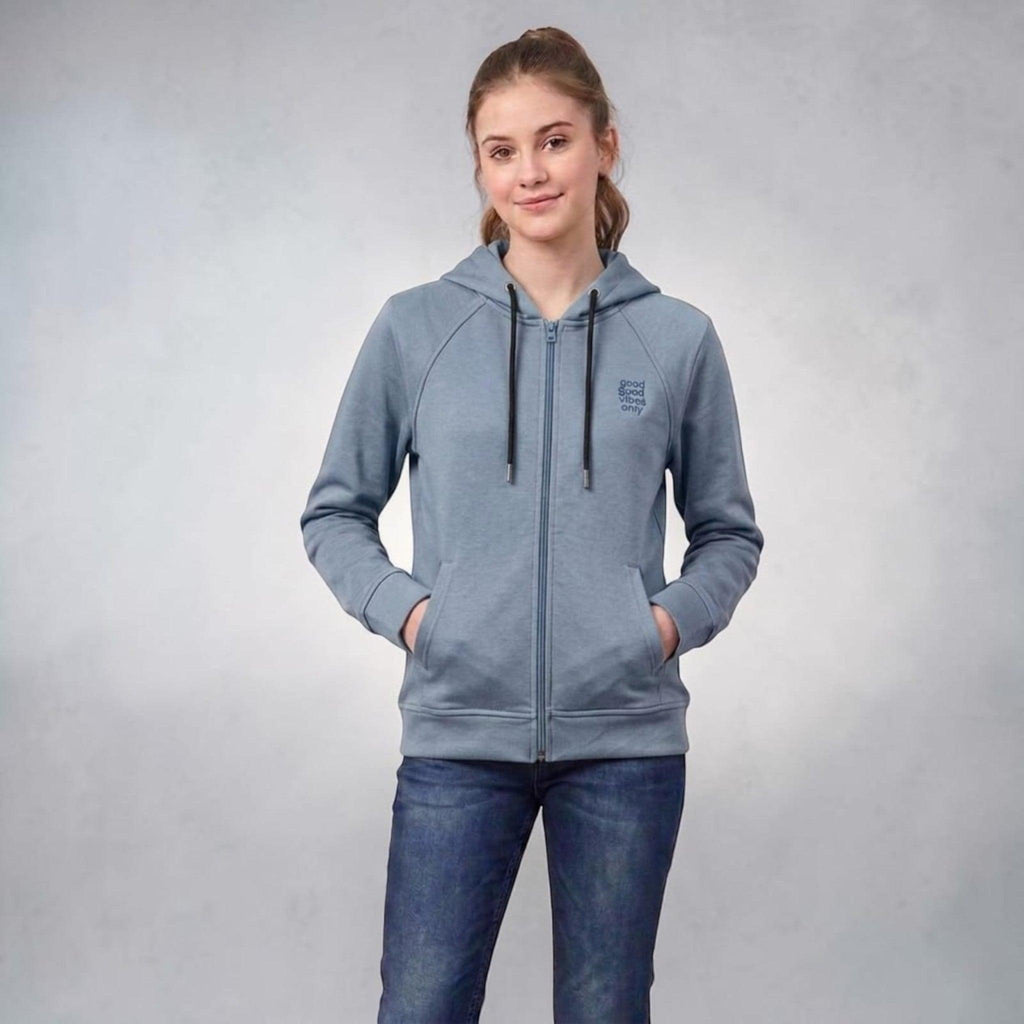 City Center blue full-zip hooded sweatshirt with raglan sleeves and good vibes only chest graphic worn by a woman