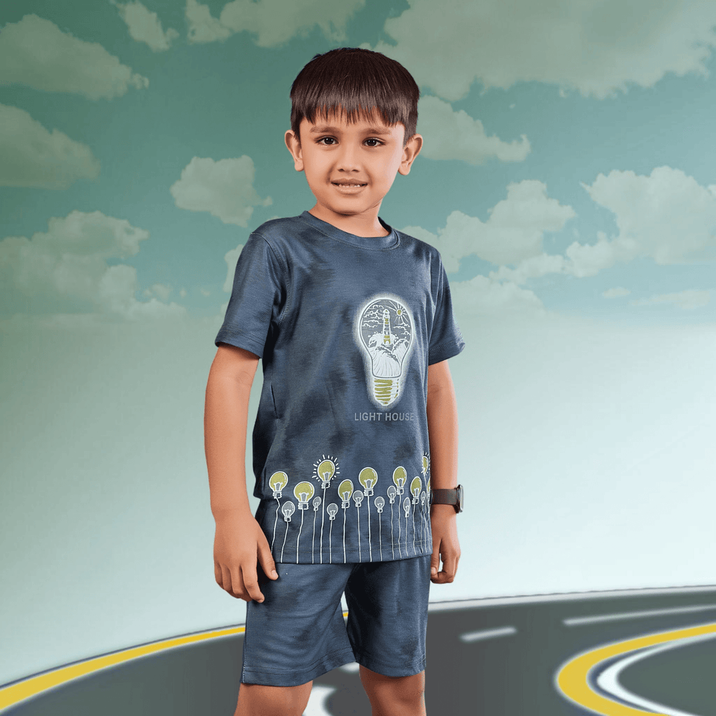 City Center boy wearing a dark grey tie-dye cotton co-ord set with a light bulb graphic print and matching shorts.