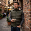 City Center Burberry olive green quilted vest with iconic check hood lining worn by a man in a city street setting.