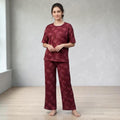 City Center women's burgundy short sleeve pajama set with a nature-inspired leaf print and relaxed wide-leg fit.