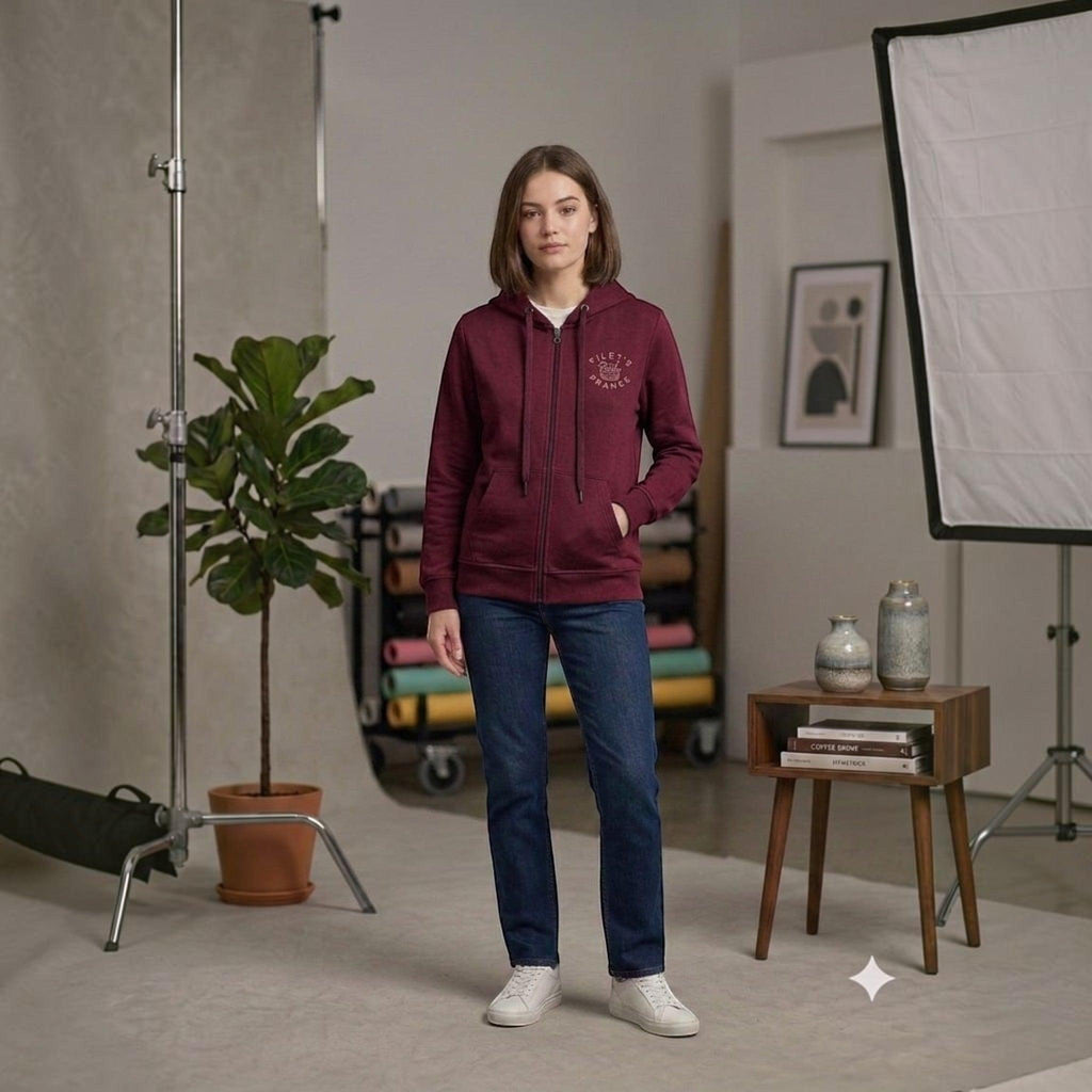 City Center burgundy full zip hooded sweatshirt with drawstring and front pockets worn by a woman with blue jeans