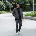 City Center men's charcoal grey lightweight hooded jacket worn by a model with matching trousers and white sneakers.