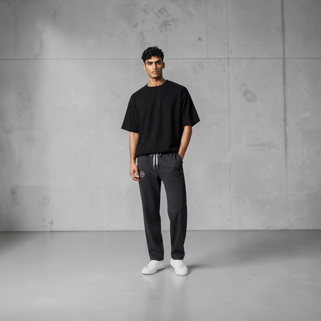 City Center casual track pants in charcoal grey with an elastic waistband and deep pockets worn by a male model.