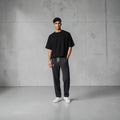 City Center casual track pants in charcoal grey with an elastic waistband and deep pockets worn by a male model.