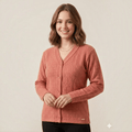 City Center lightweight coral V-neck button-up sweater worn by a smiling woman, featuring a soft textured knit.