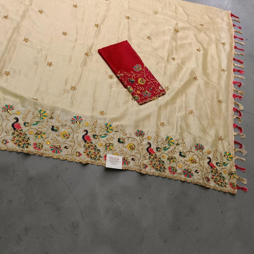 City Center cream saree with peacock embroidery, floral motifs, and a matching red unstitched blouse piece.