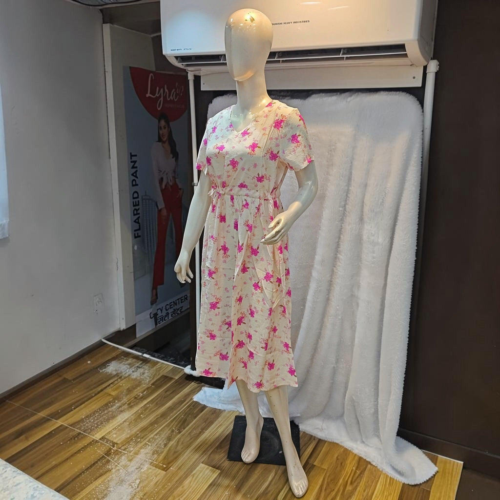 City Center cream midi dress with pink floral print, featuring a V-neck, short sleeves, and a cinched waist on a mannequin