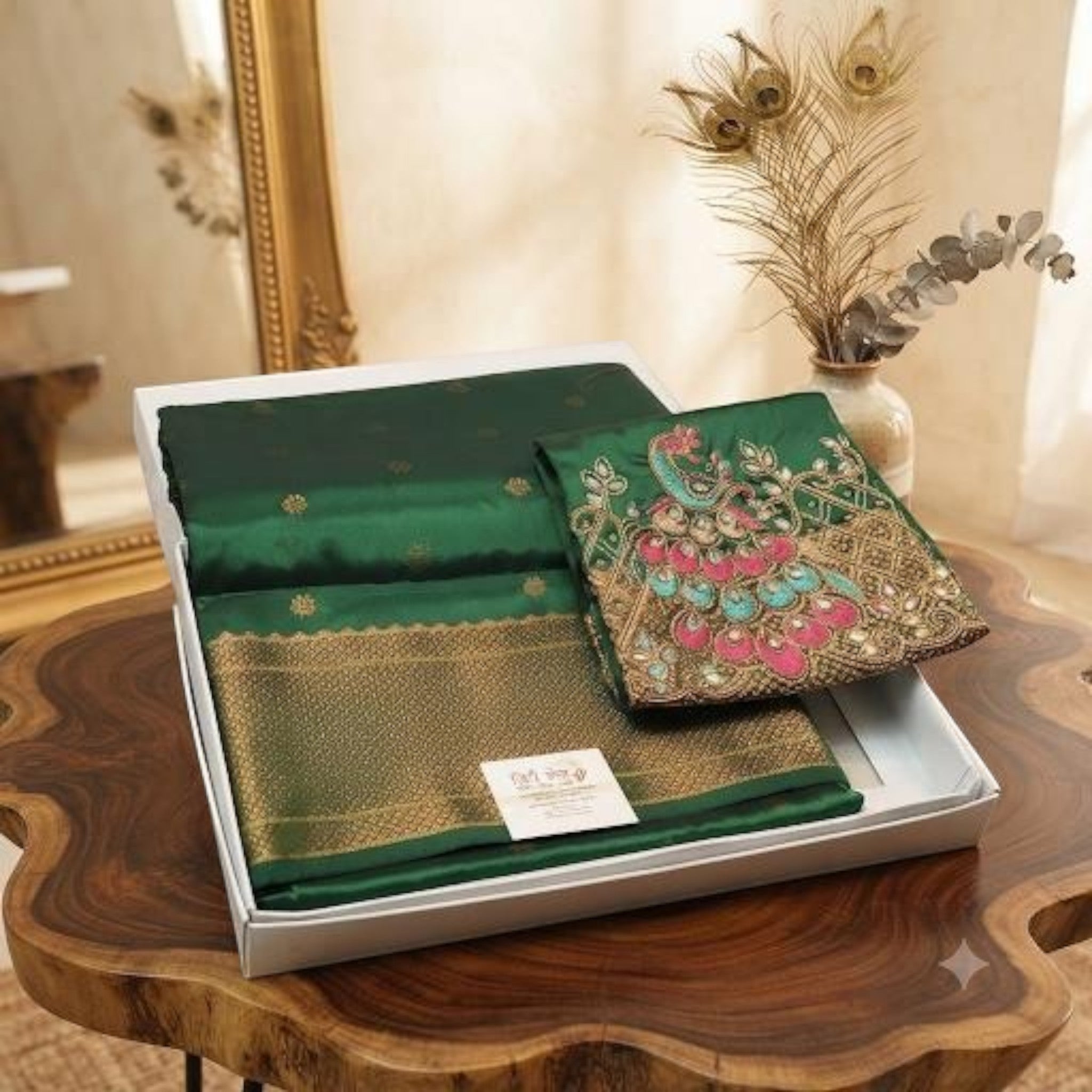 City Center emerald green Aari work saree with intricate peacock embroidery and gold zari border in a gift box