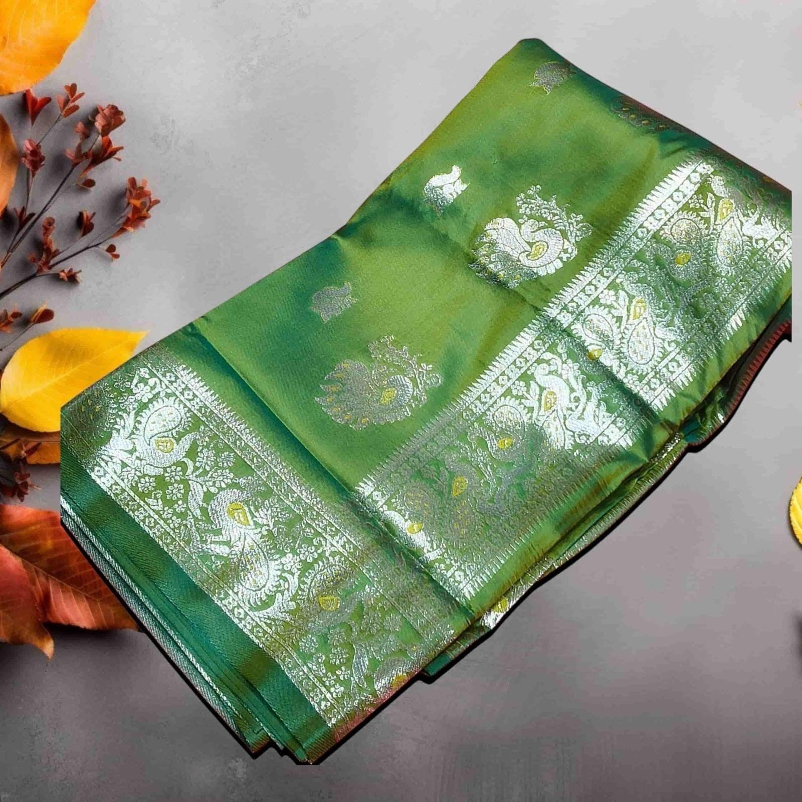 City Center emerald green pure silk Peshwai saree with intricate silver zari peacock and paisley motifs on the border.