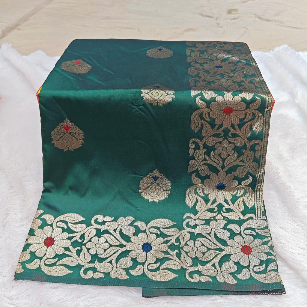 City Center Takshashila silk blend saree in emerald green with intricate gold zari and multi-color floral Mina work.