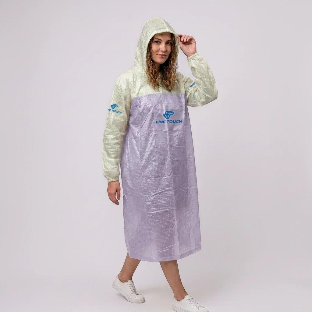 City Center FINE TOUCH lightweight hooded rain poncho in two-tone pale green and translucent purple worn by a woman.