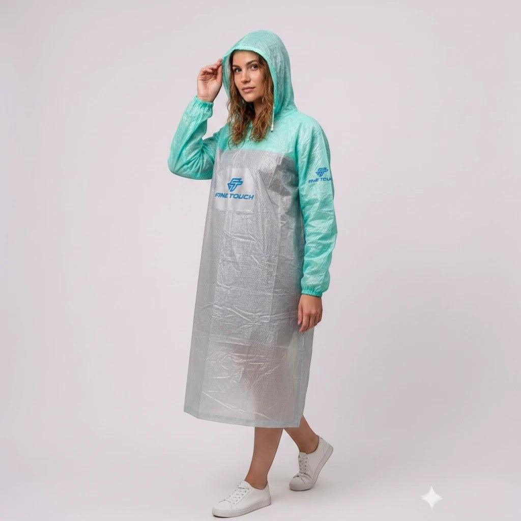 City Center FINE TOUCH lightweight hooded rain poncho in mint green and translucent grey worn by a woman.