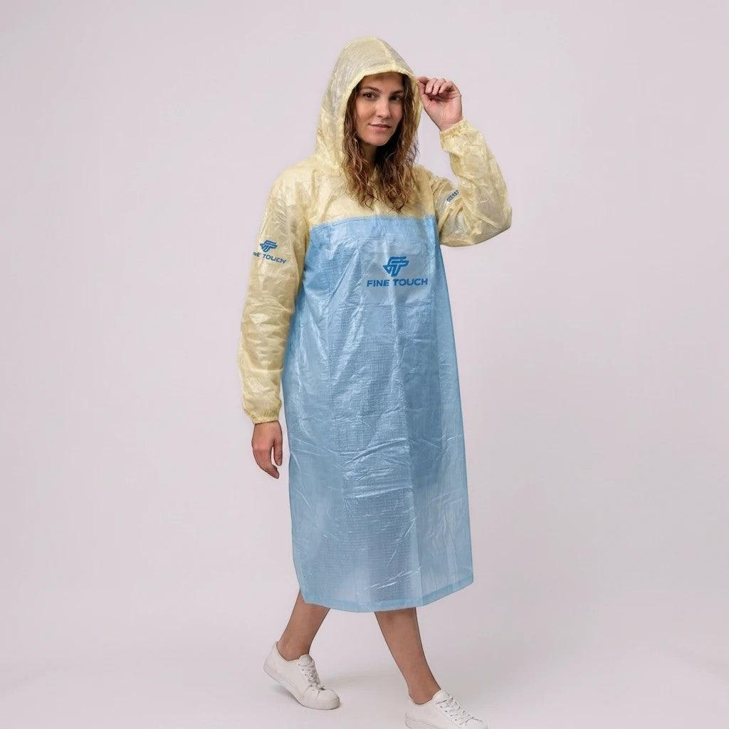 City Center FINE TOUCH lightweight hooded rain poncho in yellow and blue worn by a woman against a white background.