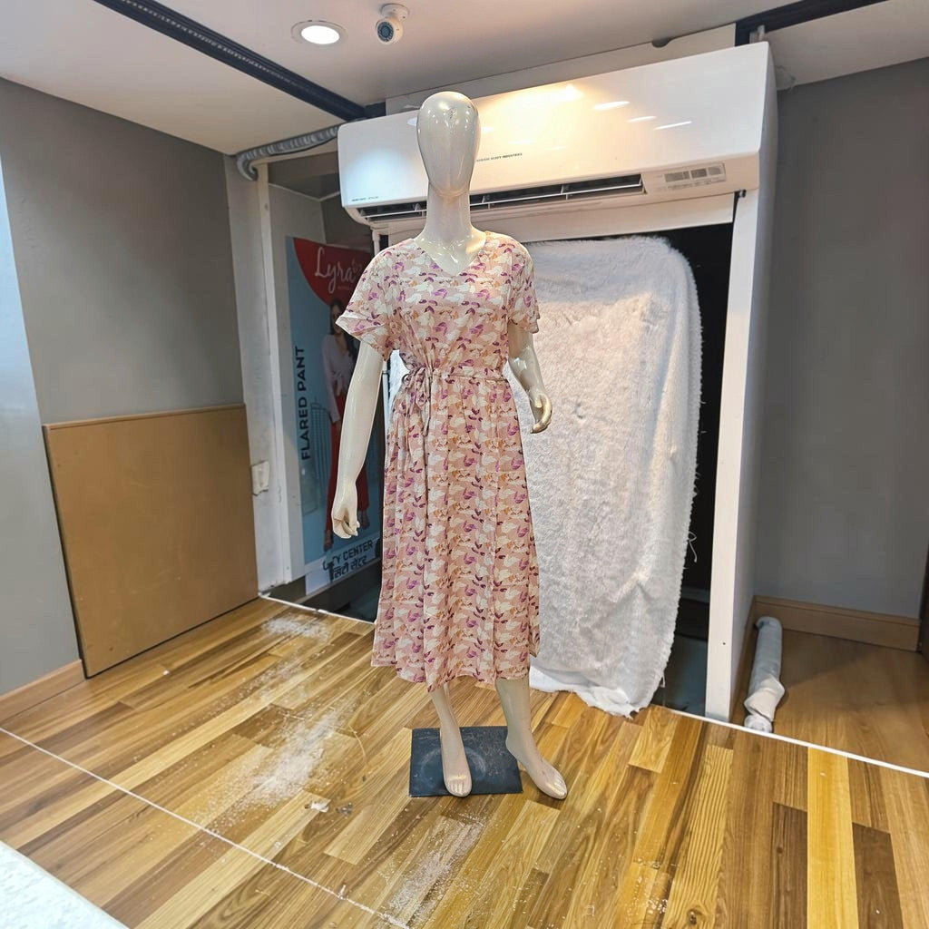 City Center floral print midi dress with a V-neck and cinched waist on a mannequin in a retail store setting.