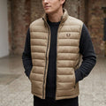 City Center Fred Perry beige quilted puffer vest with laurel wreath logo worn by a man over a dark sweater
