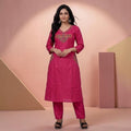 City Center fuchsia pink kurta and pant set with V-neckline and intricate ethnic embroidery on a model
