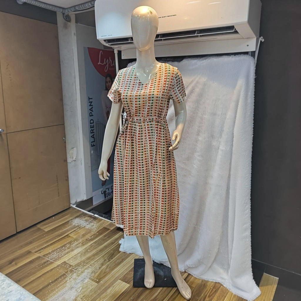 City Center midi dress with a v-neck, short sleeves, and a colorful geometric grid print on a mannequin
