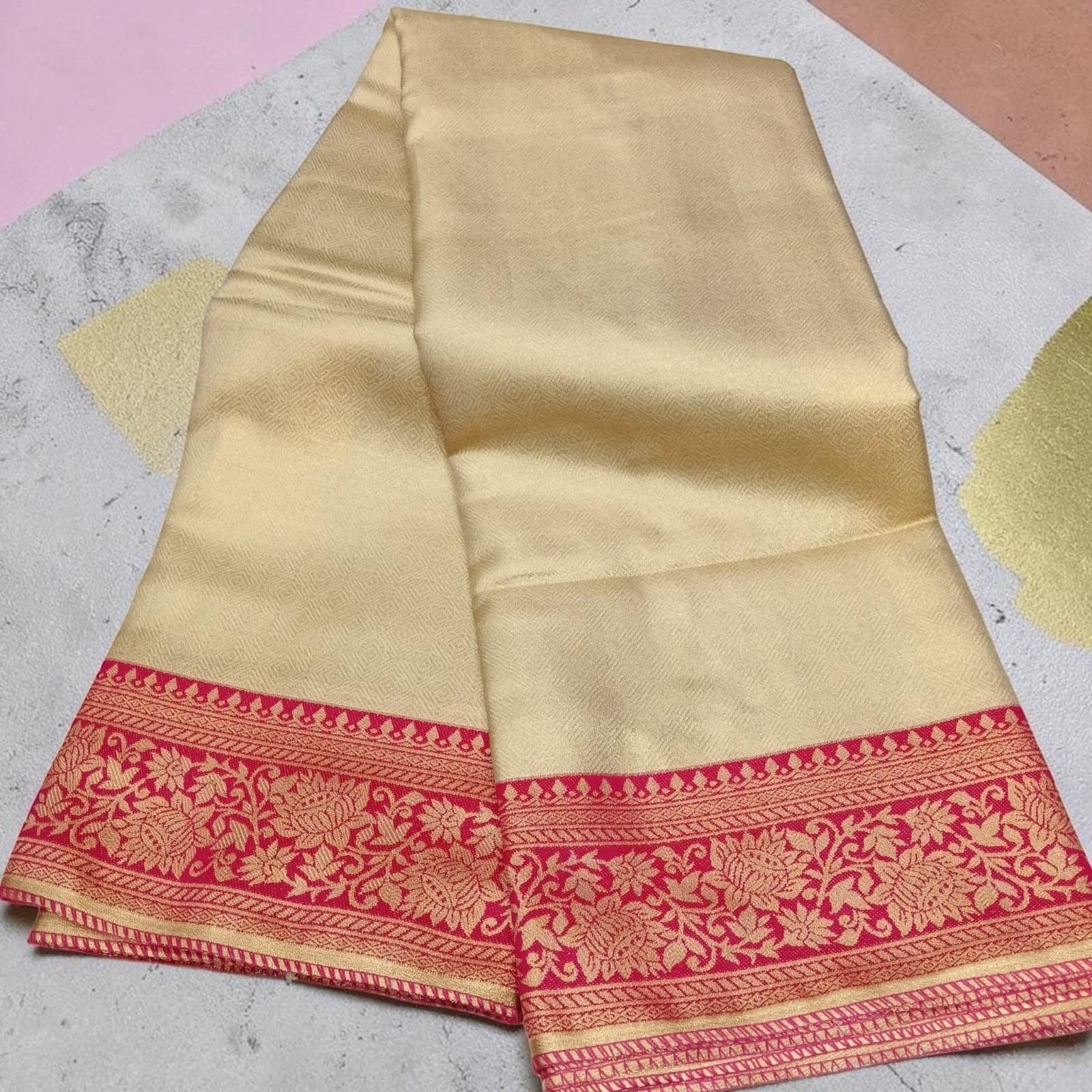 City Center gold tissue saree with a vibrant red floral zari border, featuring a lustrous and elegant drape.