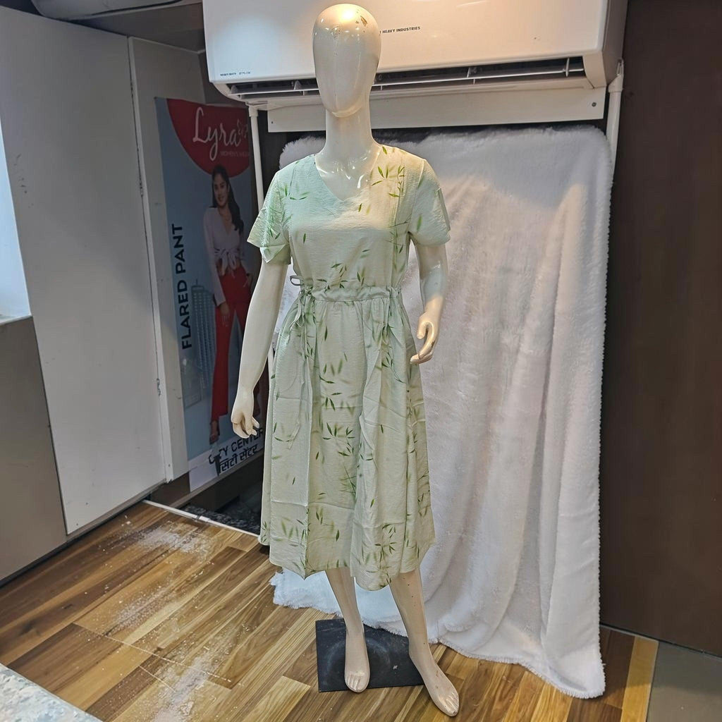 City Center light green midi dress with bamboo leaf print, short sleeves, and cinched waist on a mannequin