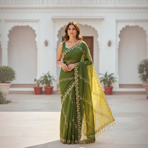 City Center green organza saree with intricate beadwork and a contrasting yellow pallu worn by a woman outdoors.