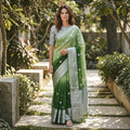 City Center organza saree in gradient green with silver zari border and floral embroidery, worn with a grey blouse.