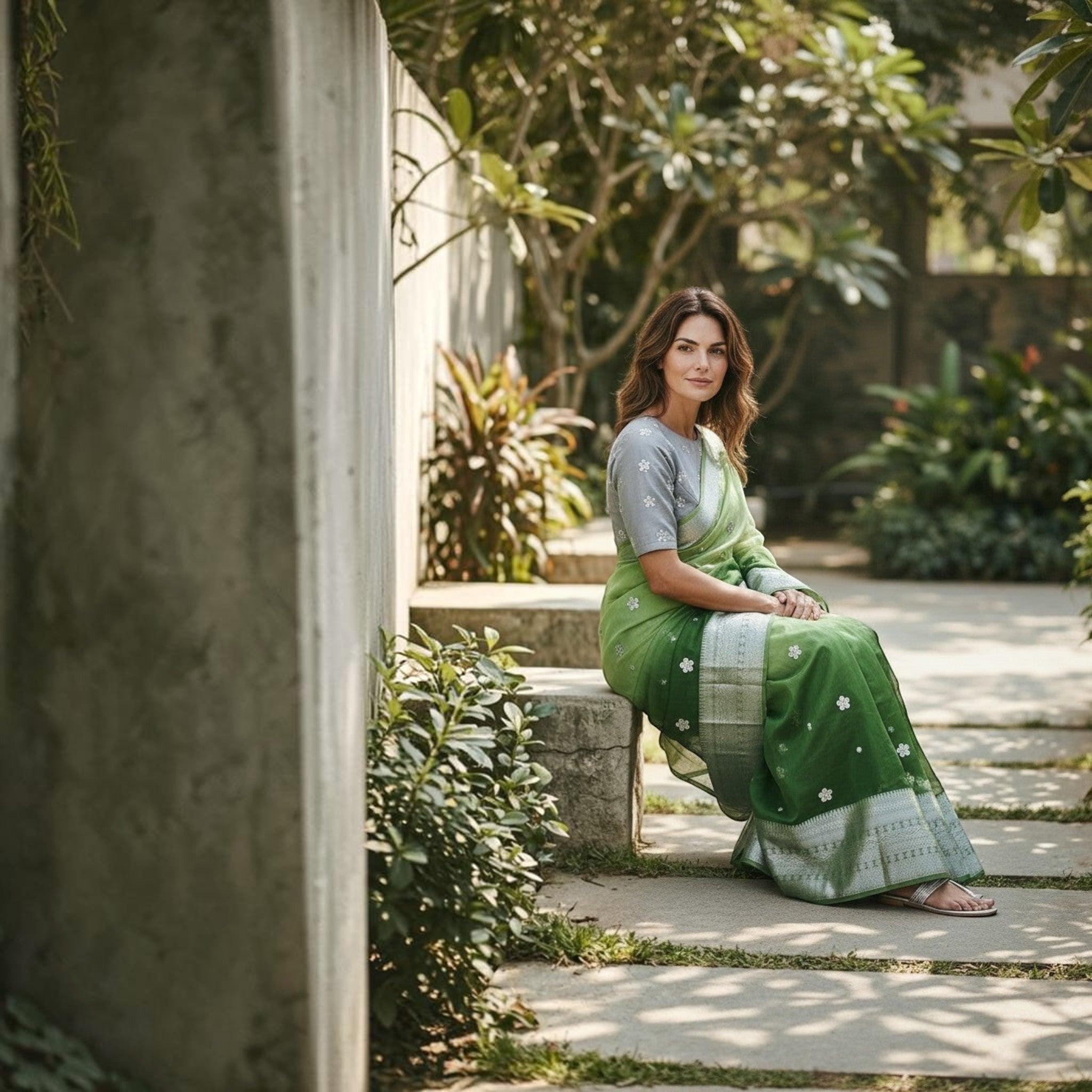City Center organza saree in green with silver floral embroidery and matching grey blouse, worn by a woman outdoors.